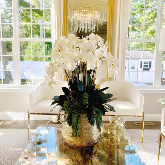 Delaney Gold Vase with multiple stems of Phalaenopsis orchids and succulents.